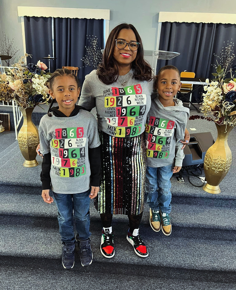 Sister and children posing in matching Black History shirts