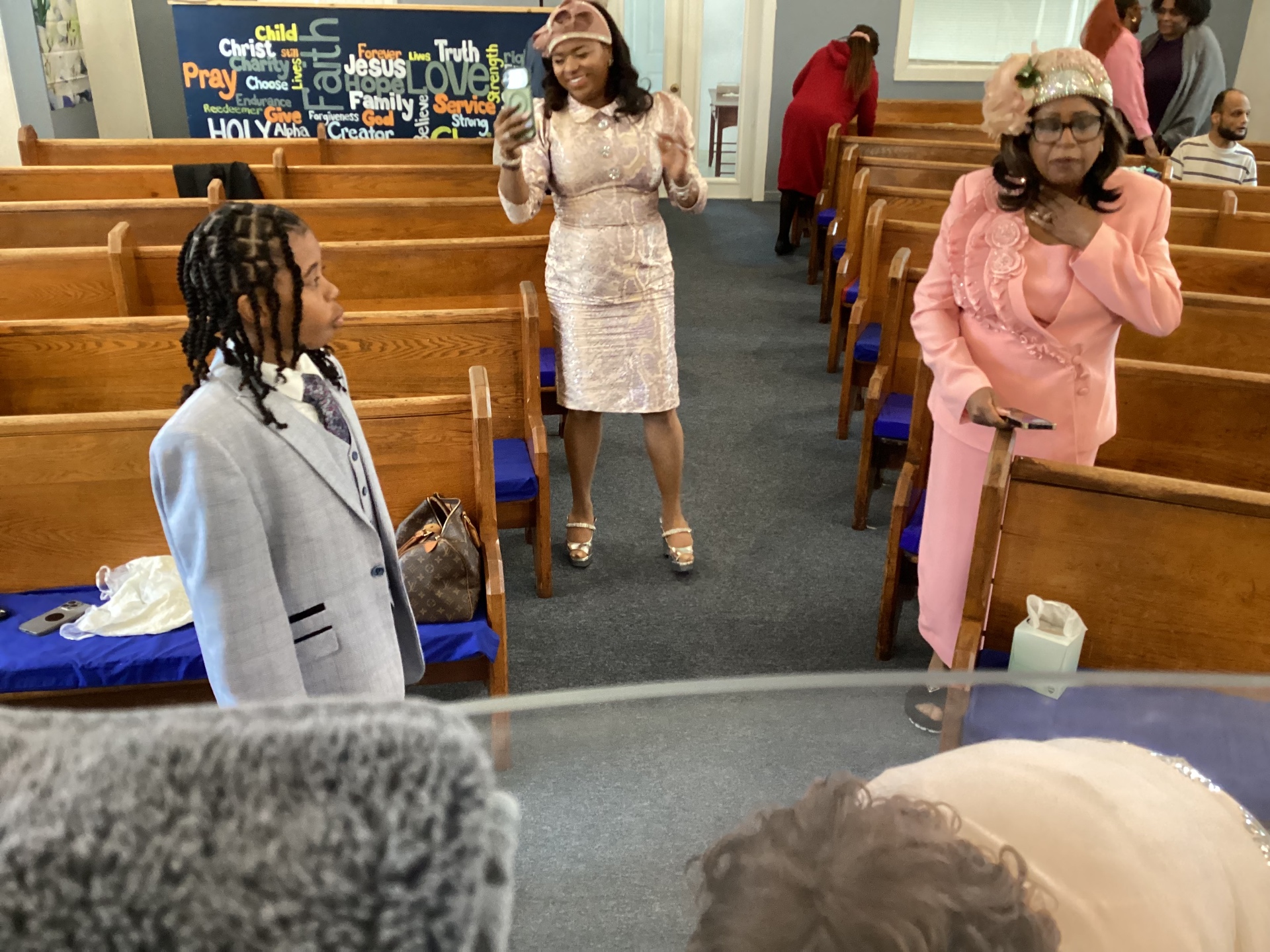 Worshippers greeting one another between the pews