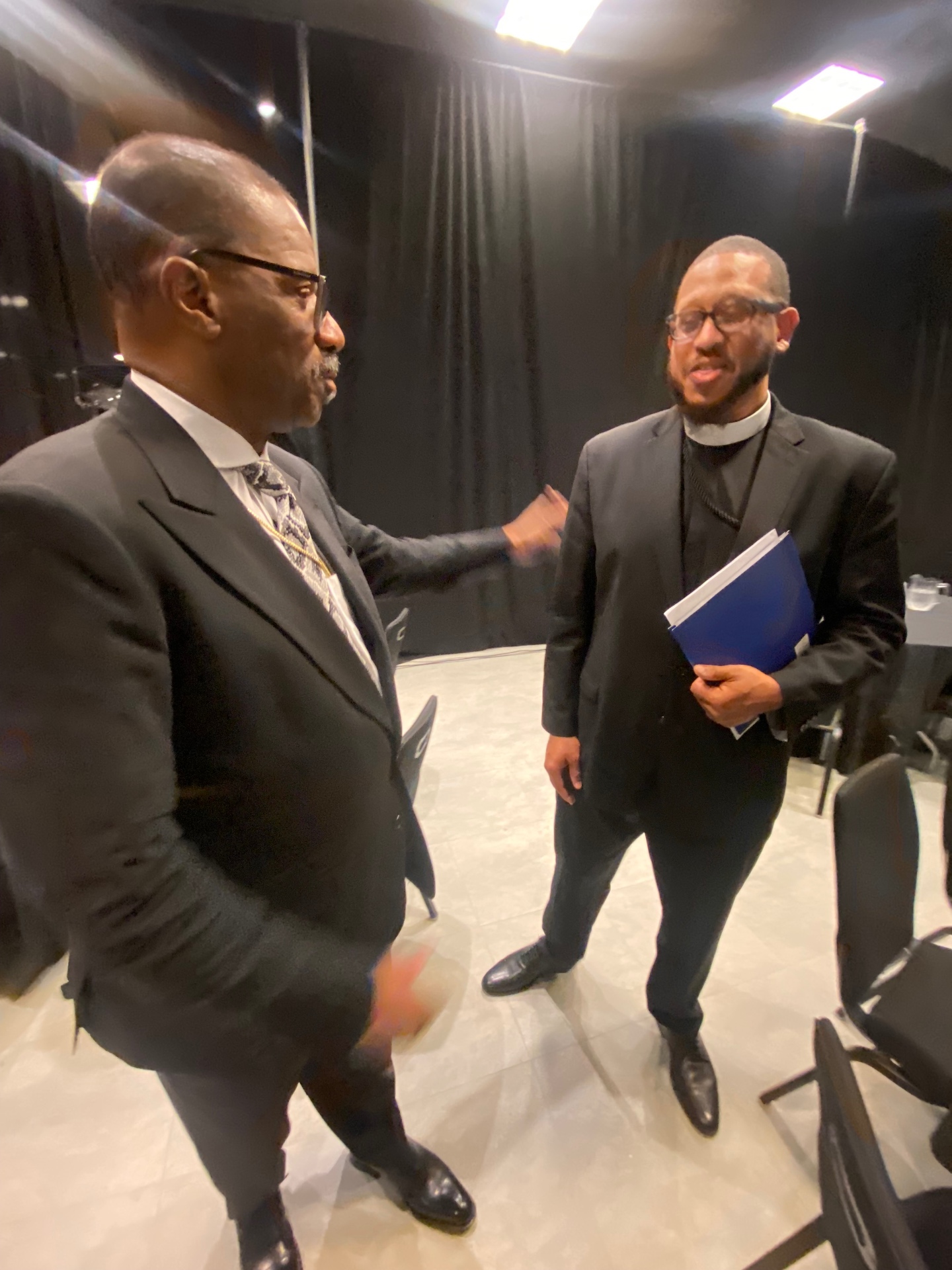 Pastor Comer in conversation with a fellow leader backstage